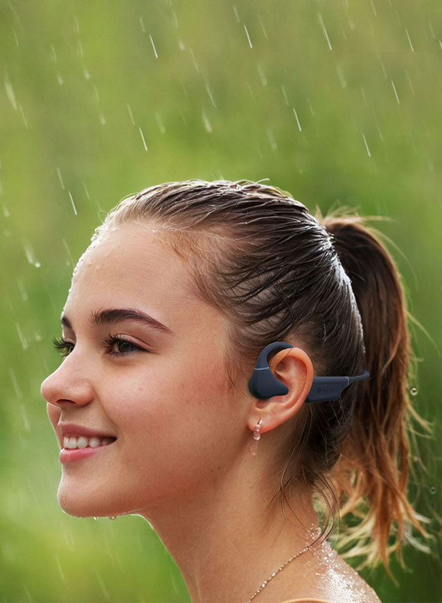 A girl wearing grey color drip-fly oz5 bone conduction headphones while enjoying her favorite music in the rain