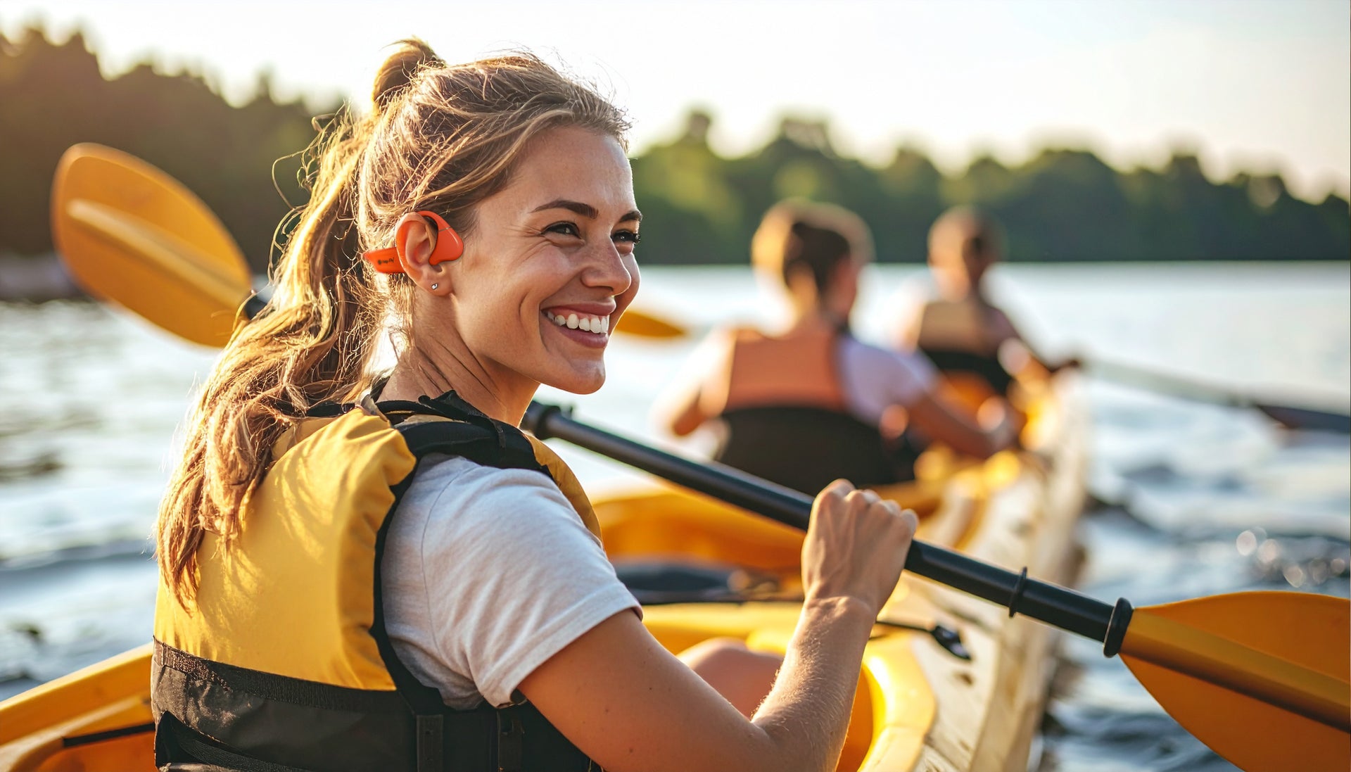 Woman paddling a kayak on a lake with a scenic background